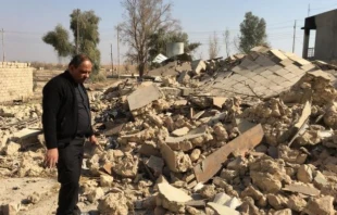 A priest examines a church destroyed by Islamic State militants in Karemlesh. Photo courtesy of the Knights of Columbus.