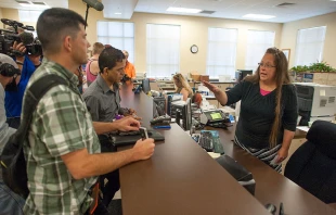 Kim Davis (at right) is pictured here in 2015, when she served as Clerk of the Courts in Rowan County, Kentucky. Citing a sincere religious objection, Davis refused to issue marriage licenses to same sex couples in defiance of a U.S. Supreme Court ruling. Credit: Ty Wright/Getty Images