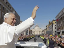 From the popemobile, Pope Leo XIV greets thousands of people lined up along Via della Conciliazione on the morning of his inaugural Mass, Sunday, May 18, 2025.