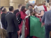 Costumed protesters struggle with personnel of the Cathedral of Our Lady of the Angels in Los Angeles during Mass on May 8, 2022.