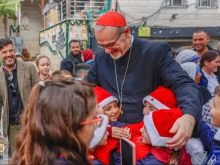 Children greet the Latin patriarch of Jerusalem, Cardinal Pierbattista Pizzaballa, during his visit to Gaza’s Holy Family Parish on Dec. 19, 2025.