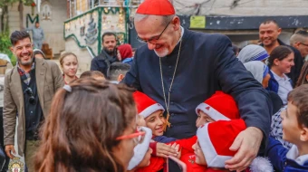 Children greet the Latin patriarch of Jerusalem, Cardinal Pierbattista Pizzaballa, during his visit to Gaza’s Holy Family Parish on Dec. 19, 2025.