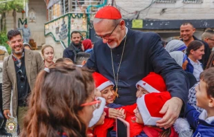 Children greet the Latin patriarch of Jerusalem, Cardinal Pierbattista Pizzaballa, during his visit to Gaza’s Holy Family Parish on Dec. 19, 2025. Credit: Photo courtesy of the Latin Patriarchate of Jerusalem