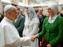 Pope Leo XIV greets pilgrims from Latvia on Nov. 24, 2025, at the Vatican.