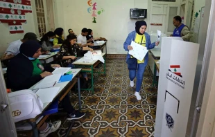 A voter casts a ballot in the parliamentary election at a polling station in the northern Lebanese city of Tripoli on May 15, 2022. Credit: IBRAHIM CHALHOUB/AFP via Getty Images