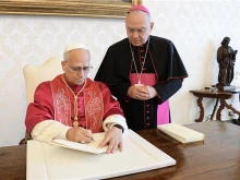 Pope Leo XIV signs his first apostolic exhortation, “Dilexi Te,” at the Vatican on Saturday, Oct. 4, 2025.