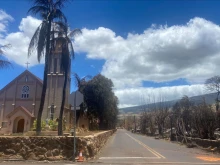 Burned houses are seen adjacent of Maria Lanakila Catholic Church on Aug. 11, 2023, in the aftermath of a wildfire in Lahaina, western Maui, Hawaii.