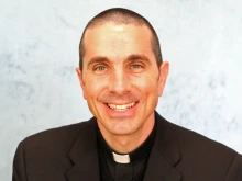 Bishop Earl Boyea of the Diocese of Lansing. University of Michigan head coach Jim Harbaugh at his introductory press conference on Dec. 30, 2014.