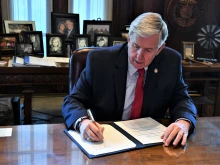 Missouri Gov. Mike Parson signs a bill in 2020.