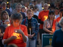 People attend a vigil at Lynnhurst Park to mourn the dead and pray for the wounded after a gunman opened fire on students at Annunciation Catholic School on Aug. 27, 2025, in Minneapolis.