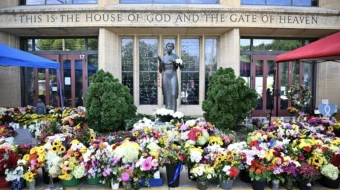 Flowers are seen on Sept. 3, 2025, outside the Annunciation Catholic Church in Minneapolis, where a shooter killed two children and injured 21 other people on Aug. 27, 2025.