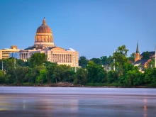 Downtown view of Jefferson City, Missouri, with the State Capitol at dusk.
