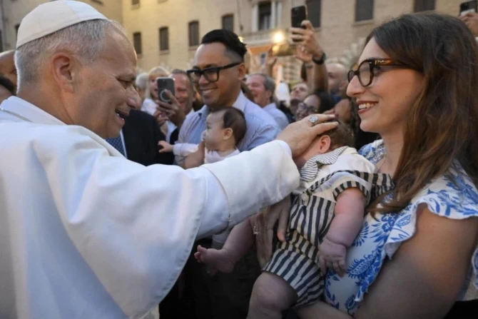 Pope blesses baby held by Mom