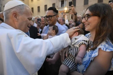Pope blesses baby held by Mom
