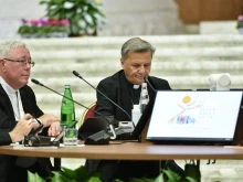 Cardinal Jean-Claude Hollerich (left), relator general of the Synod on Synodality, and Cardinal Mario Grech, secretary general of the Synod, at the Oct. 9, 2023, general congregation.