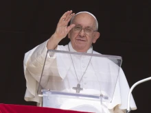 Pope Francis waves to pilgrims in St. Peter's Square during his Angelus address on Oct. 15, 2023.