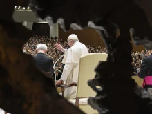 Pope Francis waves during the weekly general audience in the Vatican's Paul VI Hall on Dec. 28, 2022.