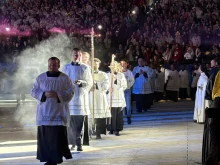 Priests process into Lucas Oil Stadium on Nov. 22, 2025, for the concluding Mass in Lucas Oil Stadium at the National Catholic Youth Conference in Indianapolis.