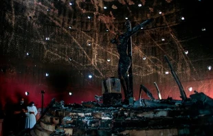 A priest and a nun pray next to the image of "Christ's Blood" after a fire burnt it at the Cathedral in Managua on July 31, 2020. Oswaldo RIVAS / POOL / AFP via Getty Images