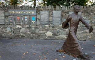 Msgr Hugh O'Flaherty bronze memorial by Alan Ryan Hall, located on Mission Road, Kilarney, Ireland.   youngoggo/shutterstock