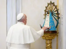 Pope Francis touches a statue of Our Lady of Luján at his general audience in the Vatican’s Apostolic Palace Dec. 2, 2020. 