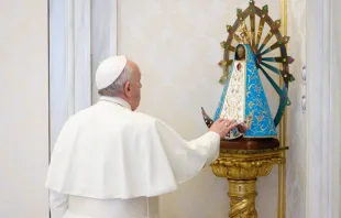 Pope Francis touches a statue of Our Lady of Luján at his general audience in the Vatican’s Apostolic Palace Dec. 2, 2020. Vatican Media.