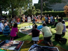 Participants kneel before bowing to a set of items during a tree planting ceremony in the Vatican gardens, Oct. 3, 2019. 