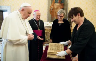Pope Francis is presented with an Aramaic prayer manuscript at the Vatican Feb. 10, 2021. Photo credits: Vatican Media/Ufficio Stampa FOCSIV. 