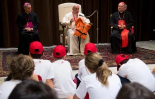 Pope Francis holds the life-jacket of the drowned refugee girl during his remarks to youth at the Vatican, May 28, 2016.   L'Osservatore Romano.