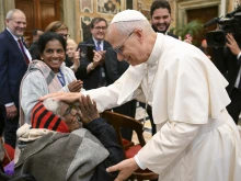 Pope Leo XIV greets an elderly woman at the Vatican on Oct. 3, 2025.