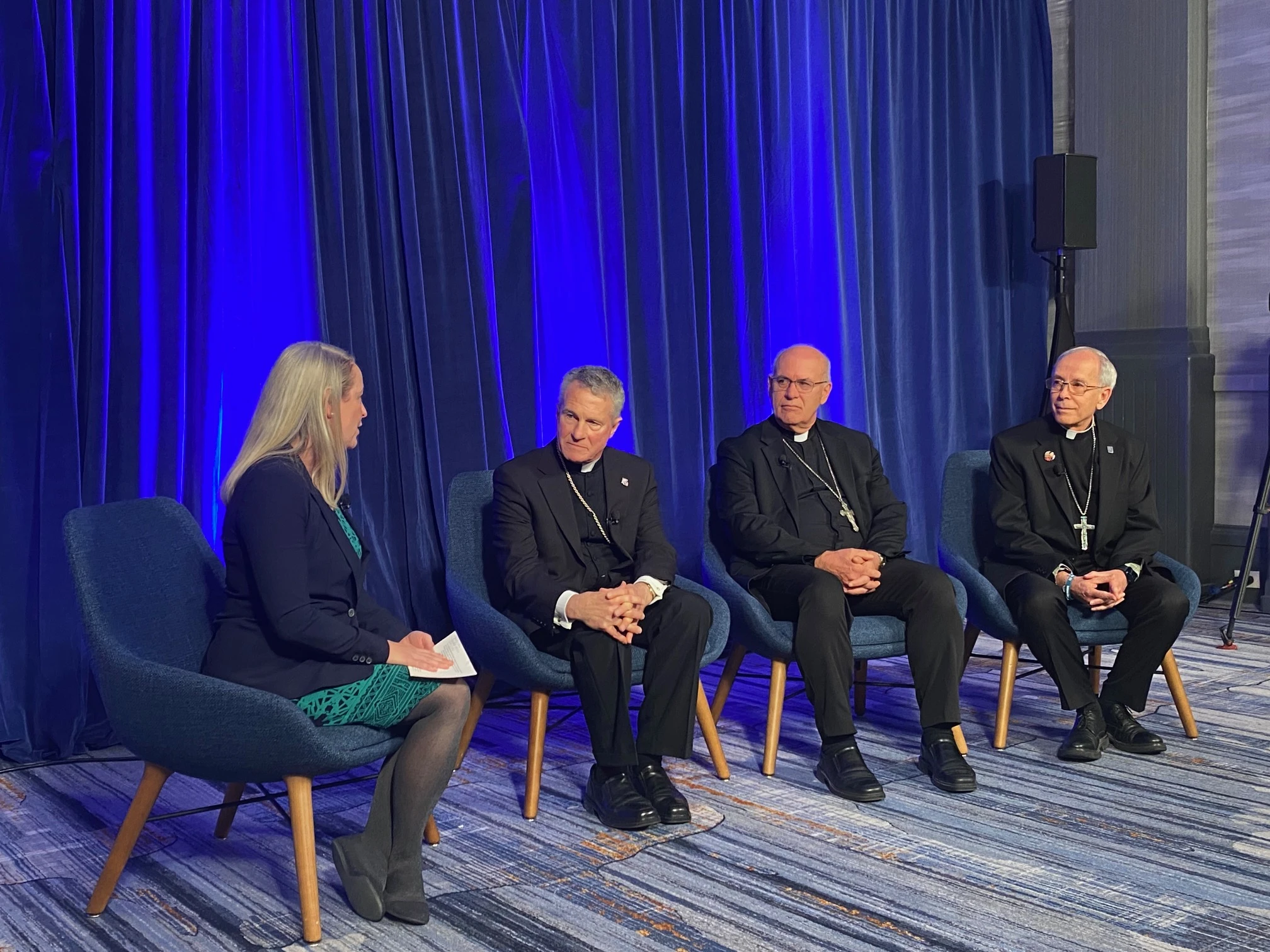 Maura Moser (far left), director of the Catholic Communications Campaign, moderates a discussion on immigration with (left to right) Archbishop Timothy P. Broglio, president of the United States Conference of Catholic Bishops; Bishop Kevin C. Rhoades, chair of the USCCB's religious liberty committee, and Bishop Mark Seitz, chairman of the USCCB's migration committee, on Nov. 11, 2025, during a press conference at the conference's fall plenary assembly in Baltimore.?w=200&h=150