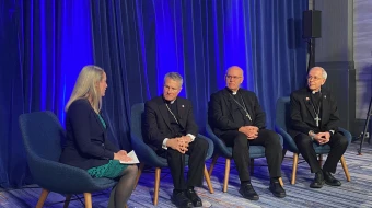 Maura Moser (far left), director of the Catholic Communications Campaign, moderates a discussion on immigration with (left to right) Archbishop Timothy P. Broglio, president of the United States Conference of Catholic Bishops; Bishop Kevin C. Rhoades, chair of the USCCB's religious liberty committee, and Bishop Mark Seitz, chairman of the USCCB's migration committee, on Nov. 11, 2025, during a press conference at the conference's fall plenary assembly in Baltimore.