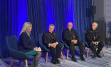 Maura Moser (far left), director of the Catholic Communications Campaign, moderates a discussion on immigration with (left to right) Archbishop Timothy P. Broglio, president of the United States Conference of Catholic Bishops; Bishop Kevin C. Rhoades, chair of the USCCB's religious liberty committee, and Bishop Mark Seitz, chairman of the USCCB's migration committee, on Nov. 11, 2025, during a press conference at the conference's fall plenary assembly in Baltimore.