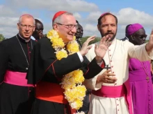 Cardinal Pietro Parolin (middle) and apostolic nuncio in Kenya and South Sudan, Archbishop Hubertus van Megen (left), are received in the Diocese of Rumbek by Bishop Christian Carlassare (right) on Aug. 17, 2023.