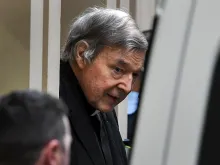 Australian Cardinal George Pell is escorted in handcuffs from the Supreme Court of Victoria in Melbourne on August 21, 2019. 