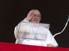 Pope Francis waves to pilgrims in St. Peter's Square on Feb. 25, 2024, during his weekly Angelus reflection. The pope canceled his audiences the day before due to mild flu conditions, according to the Vatican.