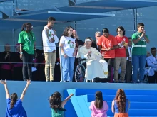 Young people greet Pope Francis as he arrives at the World Youth Day welcoming ceremony in Lisbon, Portugal, Aug. 3, 2023.