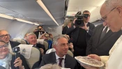 Pope Leo XIV receives a Thanksgiving pie on board the papal flight to Turkey, Thursday, Nov. 27, 2025