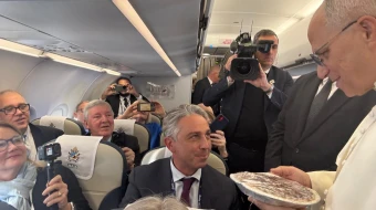 Pope Leo XIV receives a Thanksgiving pie on board the papal flight to Turkey, Thursday, Nov. 27, 2025