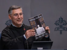 Father Enzo Fortunato, OFM Conv, communications director for St. Peter’s Basilica, holds up a copy of the first issue of the Vatican's new monthly magazine, Piazza San Pietro.