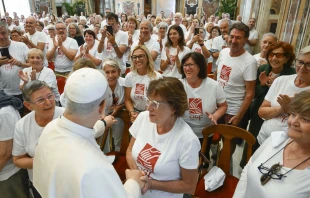 Members of St. Francis’ Work for the Poor, wearing T-shirts with the phrase “a helping hand to man every day,” meet with Pope Leo XIV on Sept. 1, 2025, in the Vatican’s Clementine Hall. Credit: Vatican Media