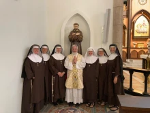 The Poor Clares of Perpetual Adoration from the Our Lady of Solitude Monastery in Tonopah, Arizona, accompanied by their local priest.
