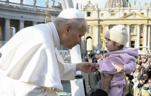 Pope Leo XIV greets a baby during the general audience in November 2025. Credit: Vatican Media