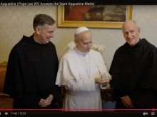 Pope Leo XIV accepts the Medal of St. Augustine from Father Robert P. Hagan, OSA, prior provincial of the Augustinian Province of St. Thomas of Villanova (right) and Father Joseph Farrell, OSA, vicar general of the Order of St. Augustine (left) in a video released on Aug. 28, 2025.