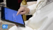 Pope Leo XIV uses a tablet to navigate the website of the new digital version of the Vatican's Pontifical Yearbook, known as the "Annuario Pontificio" in Italian.