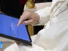 Pope Leo XIV uses a tablet to navigate the website of the new digital version of the Vatican's Pontifical Yearbook, known as the "Annuario Pontificio" in Italian.
