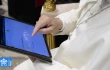 Pope Leo XIV uses a tablet to navigate the website of the new digital version of the Vatican's Pontifical Yearbook, known as the "Annuario Pontificio" in Italian.