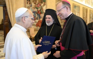 Archbishop Gintaras Grušas and Greek Orthodox Archbishop Nikitas Loulias present the signed updated Ecumenical Charter to Pope Leo XIV on Nov. 6, 2025. Credit: Vatican Media