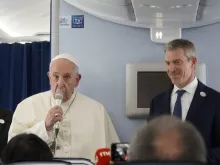 Pope Francis speaks aboard a Nov. 26 flight from Tokyo to Rome. 