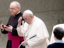 Pope Francis prays at the general audience in Paul VI Hall on Feb. 16, 2022.